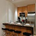 Full kitchen with stainless steel appliances, large honed granite bar