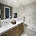 Master bathroom: see thu fireplace, deep soaker tub, hued wall to wall stone, shower