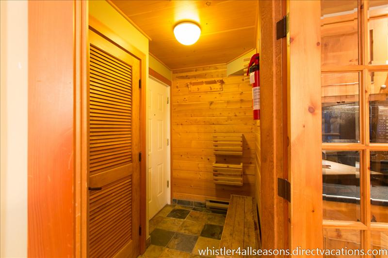 Whistler Accommodations - Front entrance includes a floor and baseboard heating to dry gear and washer/dryer behind slat door - Rentals By Owner