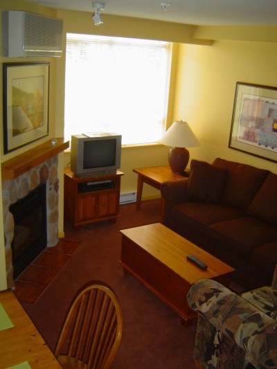 Whistler Accommodations - Living room with gas fireplace and pullout sofa - Rentals By Owner